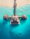 Aerial shot of the Stilt hut with palm thatch roof washed with turquoise Indian ocean waves on the white sand sandbank beach on Royalty Free Stock Photo