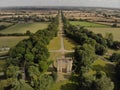 Aerial shot of the Stowe landscape gardens with Corinthian arch lined with trees in Buckinghamshire