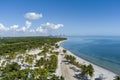 aerial shot of a stunning summer landscape at Crandon Park with blue ocean water, lush green palm trees and grass, a sandy beach