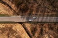 Aerial shot top view of car and truck on highway through autumn scenery landscape, drone pov