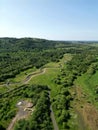 Aerial shot of a tranquil river surrounded by lush greenery