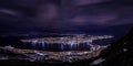 Aerial shot of a Tromso night sky with the cityscape under, Norway