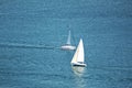 Aerial shot of two sailboats sailing in a calm sea Royalty Free Stock Photo