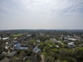 aerial shot of vast miles of homes nestled in between lush green trees with blue sky and clouds in Tybee Island Georgia Royalty Free Stock Photo