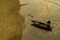 An aerial shot of a Vietnamese fisherwoman riding a wooden boat