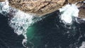 Aerial shot of waves crashing on Hamaroy, Norway