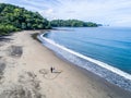 Aerial shot of wedding dress couple on the tropical beach Playa Arenillas in Costa Rica with a heart drawn into Sand Royalty Free Stock Photo