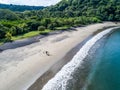 Aerial shot of wedding dress couple on the tropical beach Playa Arenillas in Costa Rica with a heart drawn into Sand Royalty Free Stock Photo