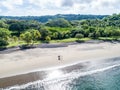 Aerial shot of wedding dress couple on the tropical beach Playa Arenillas in Costa Rica with a heart drawn into Sand Royalty Free Stock Photo