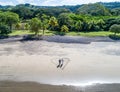 Aerial shot of wedding dress couple on the tropical beach Playa Arenillas in Costa Rica with a heart drawn into Sand Royalty Free Stock Photo