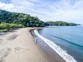 Aerial shot of wedding dress couple on the tropical beach Playa Arenillas in Costa Rica with a heart drawn into Sand Royalty Free Stock Photo