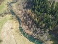Aerial shot of a wild river flowing through a forest in Bavaria, Germany