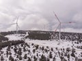 Aerial Shot of Wind Turbine farm At Snowy Highlands in Turkey at Cloudy spring day