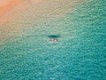 Aerial shot of woman relaxing in a kayak Summer seascape beach and blue sea water Top view from drone