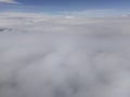 Aerial skyline landscape above the clouds view from airplane.Clouds background with blur effect and copy space Royalty Free Stock Photo