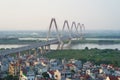 Aerial skyline view of Nhat Tan bridge crossing Red River at twilight. Hanoi cityscape Royalty Free Stock Photo