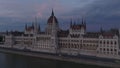 Aerial slide and pan footage of famous tourist sight. Beautiful neogothic building of Orszaghaz. Hungarian parliament at