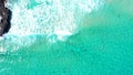 Aerial sliding shot over bodyboarders and waves in clear tropical blue water