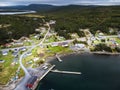 Aerial East Coast village of Whiteway Newfoundland overlooking boat docks and breakwater with vacation homes overlooking the