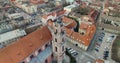 AERIAL. Smooth 360 orbit flight around beautiful Church of All Saints (Visu Sventuju) in Vilnius old town, Lithuania. Panorama of