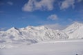 Aerial of snowy mountain slopes full of powder for freeride at ski resort on winter sunrise. Mountains range of Royalty Free Stock Photo