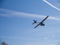 Drone airplane, low altitude passage, sunny sky with clouds