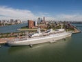 Aerial of SS Rotterdam ship moared on Katendrecht land head with skyline of towers and Erasmus bridge in the background Royalty Free Stock Photo