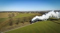 Aerial of a Steam Double-Header Freight , Passenger Combo Train Approaching Blowing Lots of Smoke Royalty Free Stock Photo