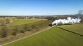 Aerial of a Steam Double-Header Freight , Passenger Combo Train Approaching Blowing Lots of Smoke