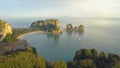 AERIAL: Stunning paradise island green karst landscape surrounds remote beach.