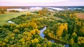 Aerial summer sunrise view. Rural landscape, river meandering in forest green trees. Morning Misty Scene. Serene atmosphere fog Royalty Free Stock Photo