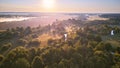 Aerial summer sunrise view. Rural landscape, river meandering in forest green trees. Morning Misty Scene. Serene atmosphere fog Royalty Free Stock Photo