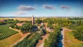 Aerial summer view from flying drone of Pomposa Abbey tower among the green vineyards. Royalty Free Stock Photo