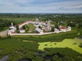 Aerial summer view of white old monastery with golden domes among green fields in Rostov the Great city. Russia Royalty Free Stock Photo