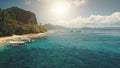 Aerial sun beach at ocean bay pier with boats, vessels on water. Relax of tourists on tropic island Royalty Free Stock Photo