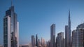 Aerial sunrise view of Dubai Downtown skyline with many towers night to day timelapse.