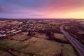 Aerial sunset scene with view on a highway and town residential and commercial area. Galway city, Ireland. Rich saturated warm and Royalty Free Stock Photo