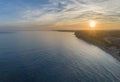 Aerial sunset seascape, of Praia Porto de Mos Beach and seaside cliff formations along coastline of Lagos city Portugal