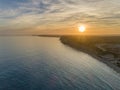 Aerial sunset seascape, of Praia Porto de Mos Beach and seaside cliff formations along coastline of Lagos city Portugal