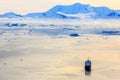 Aerial sunset surface of Neco bay surrounded by glaciers and mountains with antarctic cruise liner standing still among