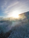 Aerial sunset view of foggy winter pine forest in Low Tatras mountains of Slovakia Royalty Free Stock Photo