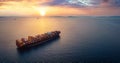 Aerial sunset view of a large, heavy loaded container cargo ship