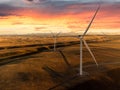 Aerial sunset windmills producing sustainable energy with mountains at background near Pincher Creek Royalty Free Stock Photo