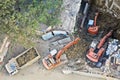 Aerial of three diggers moving earth