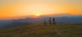 AERIAL: Friends on a mountain biking adventure pedalling up a mountain at sunset