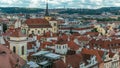 Aerial timelapse view of the traditional red roofs of the city of Prague, Czech Republic with the church of St. Jilji