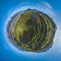 Aerial tiny planet of the swamp and mountains on horizon