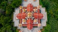 Aerial top angle drone view closeup above pagoda temple of Wat PraMahathadchedi Pakdeeprakad or Tang Sai temple on mountain forest