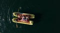 Aerial top-down close up on traditional Uros boat made of Totora plant with tourists on board