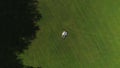 AERIAL TOP DOWN Young couple in love lying down in green meadow on sunlit day Royalty Free Stock Photo